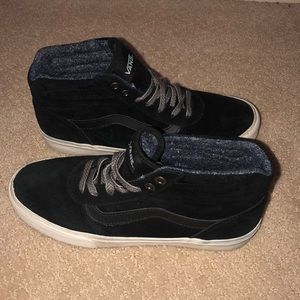 Black and white high top vans